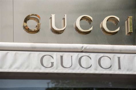 who is gucci owned by.